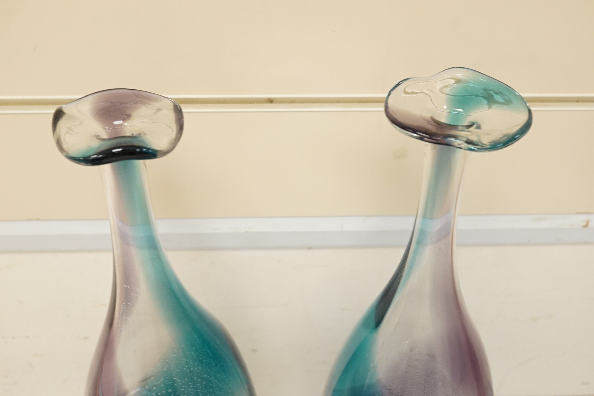 Three art glass vases to include a pair of purple and blue stem vases, 42cm high